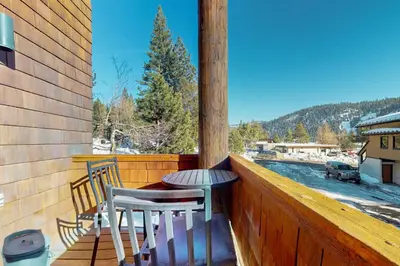 a balcony with two chairs and a table on a porch at Christy Lane Condo in Olympic Valley