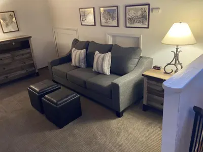 a living room with a couch and a table at Streamside Townhome in Kings Beach