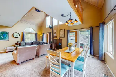 a living room with a table and chairs and a couch at Solvang Family Getaway in Truckee