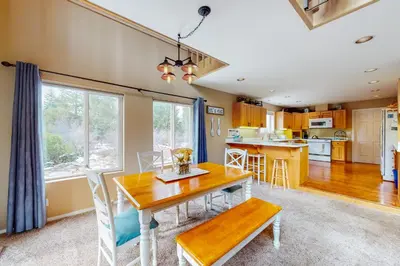 a kitchen and dining room with a wooden table and chairs at Solvang Family Getaway in Truckee