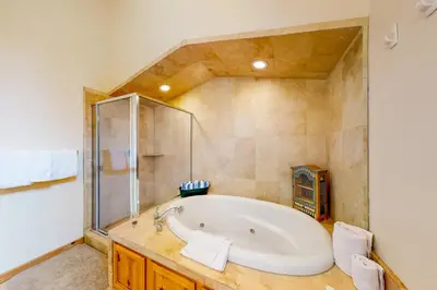 a large bathroom with a tub and a shower at Snowpeak Tahoe Donner Golf Course Views in Truckee