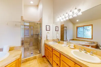 a bathroom with two sinks and a shower at Snowpeak Tahoe Donner Golf Course Views in Truckee