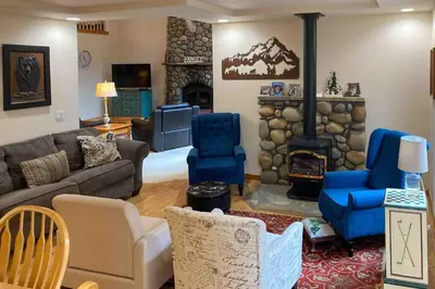 a living room with a couch and a fireplace at Snowpeak Tahoe Donner Golf Course Views in Truckee