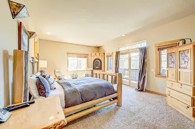 a bedroom with a bed and a desk in a room at Stockholm Luxury Retreat in Truckee