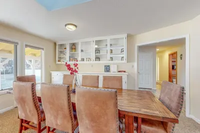 a kitchen and dining room with a wooden table and chairs at Back Nine Bungalow in South Lake Tahoe