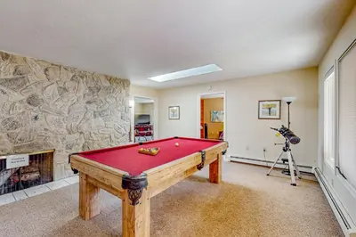 a room with a pool table and a fireplace at Back Nine Bungalow in South Lake Tahoe
