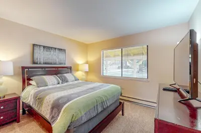 a bedroom with a bed and a flat screen tv at Back Nine Bungalow in South Lake Tahoe