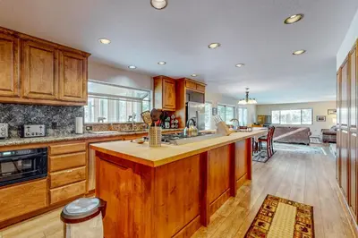 a kitchen with wooden cabinets and a large kitchen island at Back Nine Bungalow in South Lake Tahoe