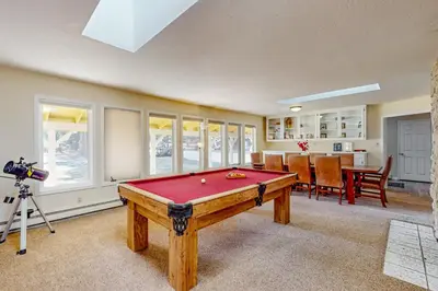 a pool table in a living room with a camera at Back Nine Bungalow in South Lake Tahoe