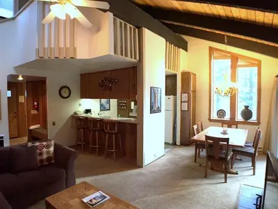 a living room and kitchen with a couch and a table at 102 Standard Condo in Mammoth Lakes