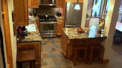 a kitchen with granite counter tops and stainless steel appliances at 114 Premium Condo in Mammoth Lakes