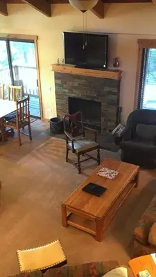 a living room with a fireplace and a tv at 114 Premium Condo in Mammoth Lakes