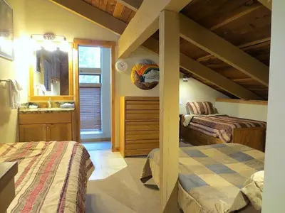 a bedroom with two beds and a sink in a room at 114 Premium Condo in Mammoth Lakes