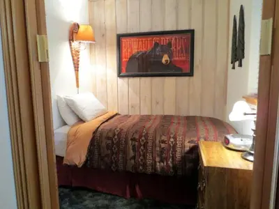 a bedroom with a bed and a picture of a bear at 141 Premium Condo in Mammoth Lakes