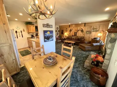 a kitchen and living room with a wooden table and chairs at 141 Premium Condo in Mammoth Lakes