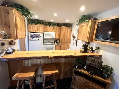 a kitchen with wooden cabinets and a counter top at 141 Premium Condo in Mammoth Lakes