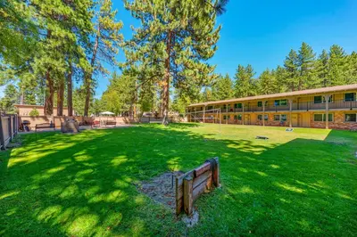 a park with a bench in front of a building at The Lodge at Lake Tahoe in South Lake Tahoe