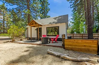 a tiny house in the woods with a table and chairs at Firelite Lodge in Tahoe Vista