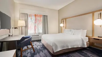 a hotel room with a bed and a desk at Fairfield Inn & Suites by Marriott Reno Sparks in Sparks