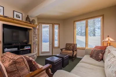 a living room with a couch and a tv at Mammoth Green # 105 in Mammoth Lakes