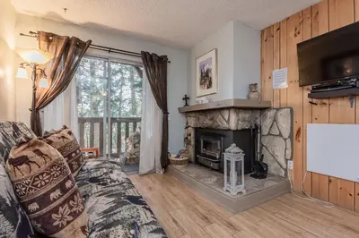 a living room with a fireplace and a tv at Mammoth View Villas # 34 in Mammoth Lakes