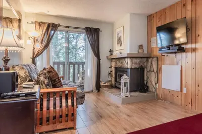 a living room with a fireplace and a television at Mammoth View Villas # 34 in Mammoth Lakes