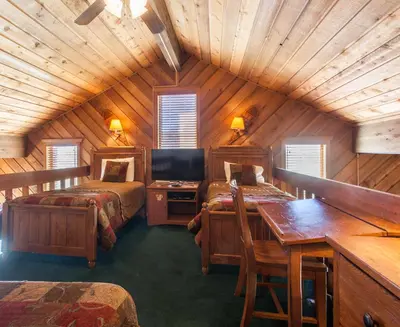 a room with two beds and a desk in a cabin at Snowcreek # 320 - Phase II in Mammoth Lakes