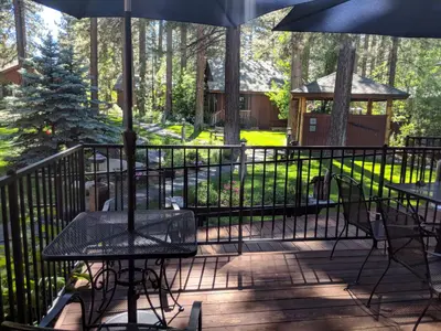 a patio with tables and chairs and an umbrella at Black Bear Lodge in South Lake Tahoe