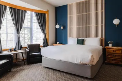 a hotel room with a bed and a chair at Black Bear Lodge in South Lake Tahoe