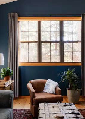 a living room with a chair and a large window at Black Bear Lodge in South Lake Tahoe