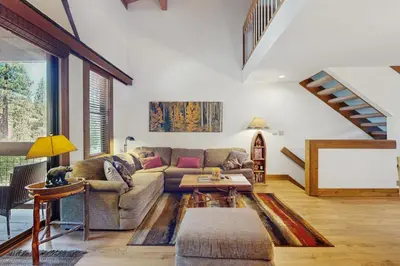 a living room with a couch and a table at Silver Strike at Northstar in Kingswood Estates