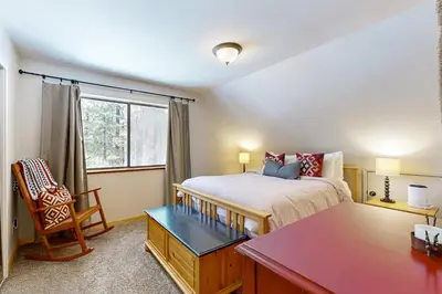 a bedroom with a bed and a desk and a window at The Hideaway in Meadow Lake Park