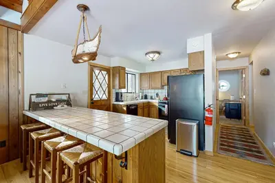 a kitchen with a counter and a refrigerator at The Hideaway in Meadow Lake Park