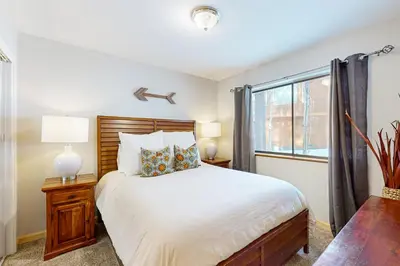 a bedroom with a large bed and a window at The Hideaway in Meadow Lake Park