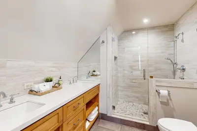 a bathroom with a shower and a sink and a toilet at The Hideaway in Meadow Lake Park