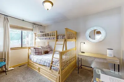 a bedroom with a bunk bed and a desk with a mirror at The Hideaway in Meadow Lake Park