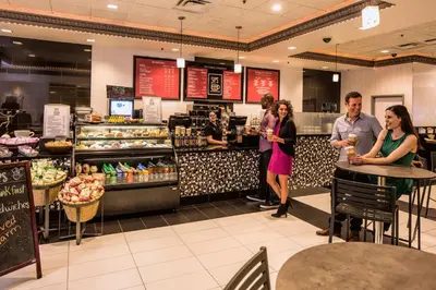 a group of people standing at a counter in a bakery at Circus Circus Reno, A Caesars Destination in Reno