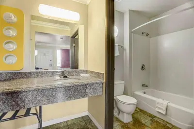 a bathroom with a sink and a toilet and a tub at Motel 6-Fresno, CA - Belmont Ave in Fresno