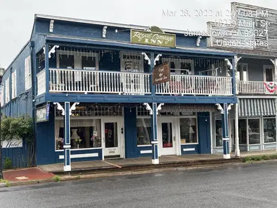 a blue building on the side of a street at Americas Best Value Inn Royal Carriage in Jamestown