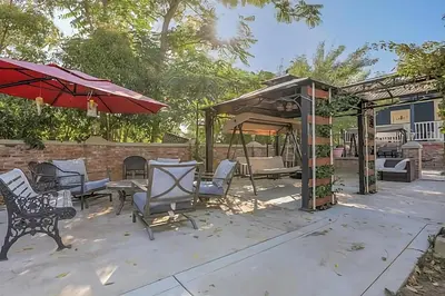 a patio with a table and chairs and an umbrella at Americas Best Value Inn Royal Carriage in Jamestown