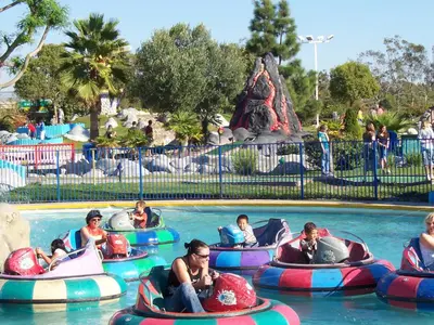 a group of people riding onlatable tubes in a pool at a water park at Summerfield Inn Fresno Yosemite in Fresno