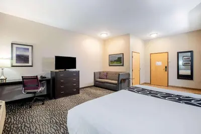 a hotel room with a bed and a desk and a tv at La Quinta Inn by Wyndham Livermore in Livermore