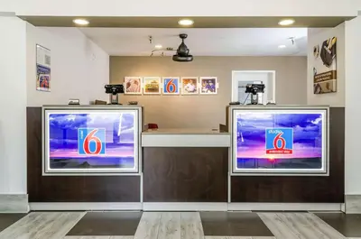 two large televisions sitting on a counter in a room at Motel 6-Fresno, CA - Yosemite Hwy in Pinedale