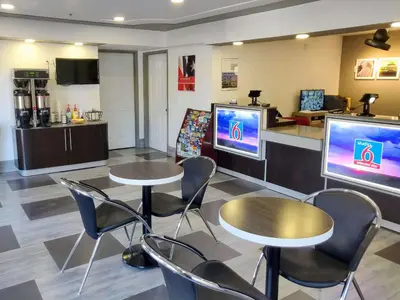 a waiting room with two tables and two televisions at Motel 6-Fresno, CA - Yosemite Hwy in Pinedale