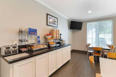 a kitchen with a counter with some food on it at Best Western Visalia Hotel in Visalia