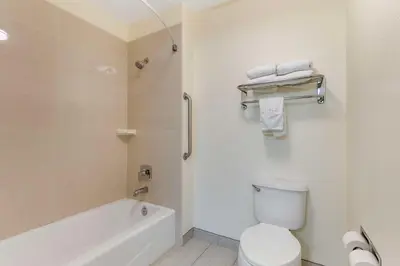 a bathroom with a tub and a toilet and a sink at Best Western Visalia Hotel in Visalia