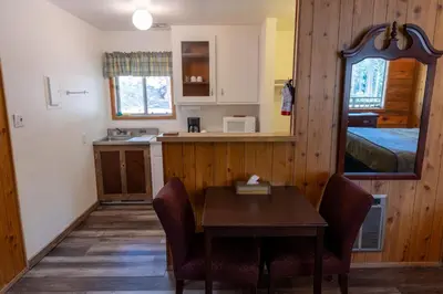 a kitchen with a table and chairs in a room at The Tamarack Lodge in Lakeshore