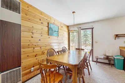 a dining room with a wooden table and chairs at Tahoma Getaway in Tahoma
