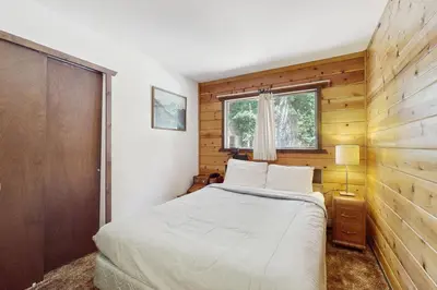 a small bedroom with a bed and a window at Tahoma Getaway in Tahoma