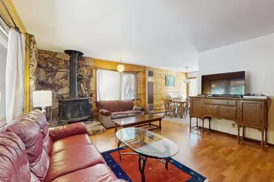 a living room with a couch and a fireplace at Tahoma Getaway in Tahoma